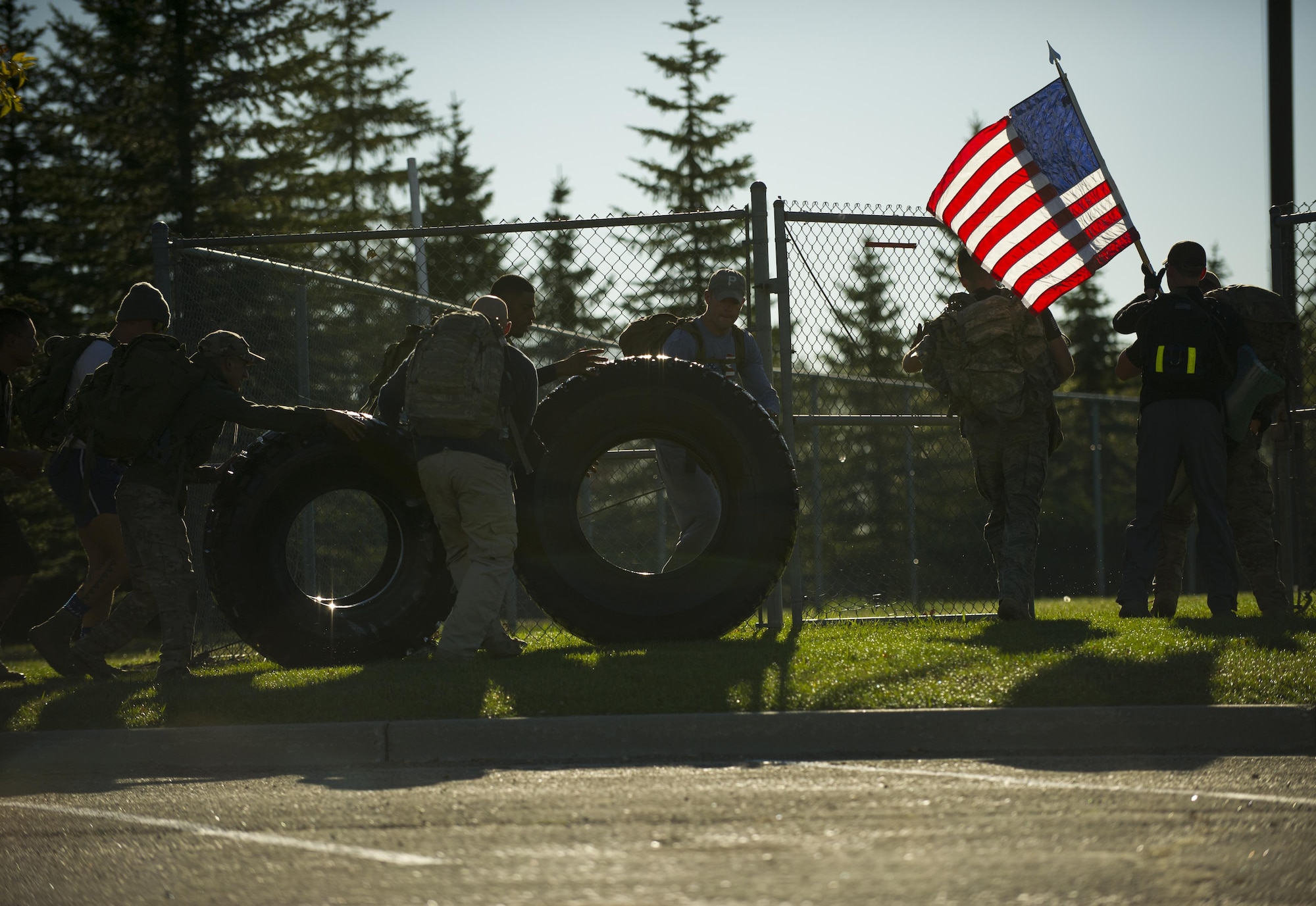 Airmen push tires during the GoRuck Team Cohesion Challenge at Minot Air Force Base, N.D., Sept. 29, 2016. During the five-hour event, participants completed a number of different challenges that demonstrated teamwork. (U.S. Air Force photo/Senior Airman Apryl Hall)