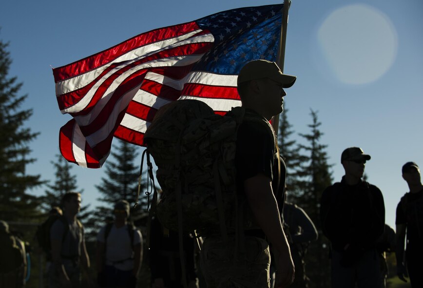 A participant of the GoRuck Team Cohesion Challenge holds the flag during a team-building exercise at Minot Air Force Base, N.D., Sept. 29, 2016. The day consisted of completing various physical tasks as a team throughout a five-hour ruck march. (U.S. Air Force photo/Senior Airman Apryl Hall)
