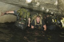Airmen climbed through a tunnel during the GoRuck Team Cohesion Challenge at Minot Air Force Base, N.D., Sept. 29, 2016. This part of the event simulated a special operations mission that requires fitting equipment through tight and uncomfortable spaces. (U.S. Air Force photo/Senior Airman Apryl Hall)