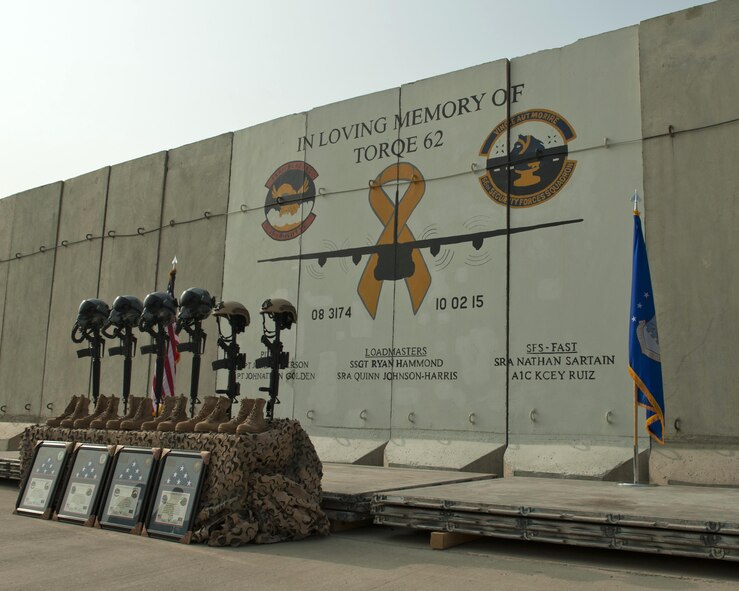 Battlefield crosses representing the six Airmen lost during a C-130J Super Hercules crash, are placed in front of a mural in memory of Torque 62 at Bagram Airfield, Afghanistan, Oct. 2. A ceremony was held to remember and honor those lost, including Hanscom Senior Airmen Kcey Ruiz and Nathan Sartain, when Torque 62 crashed during takeoff at Jalalabad Airfield, Afghanistan, Oct. 2, 2015. (U.S. Air Force photo by Capt. Korey Fratini)