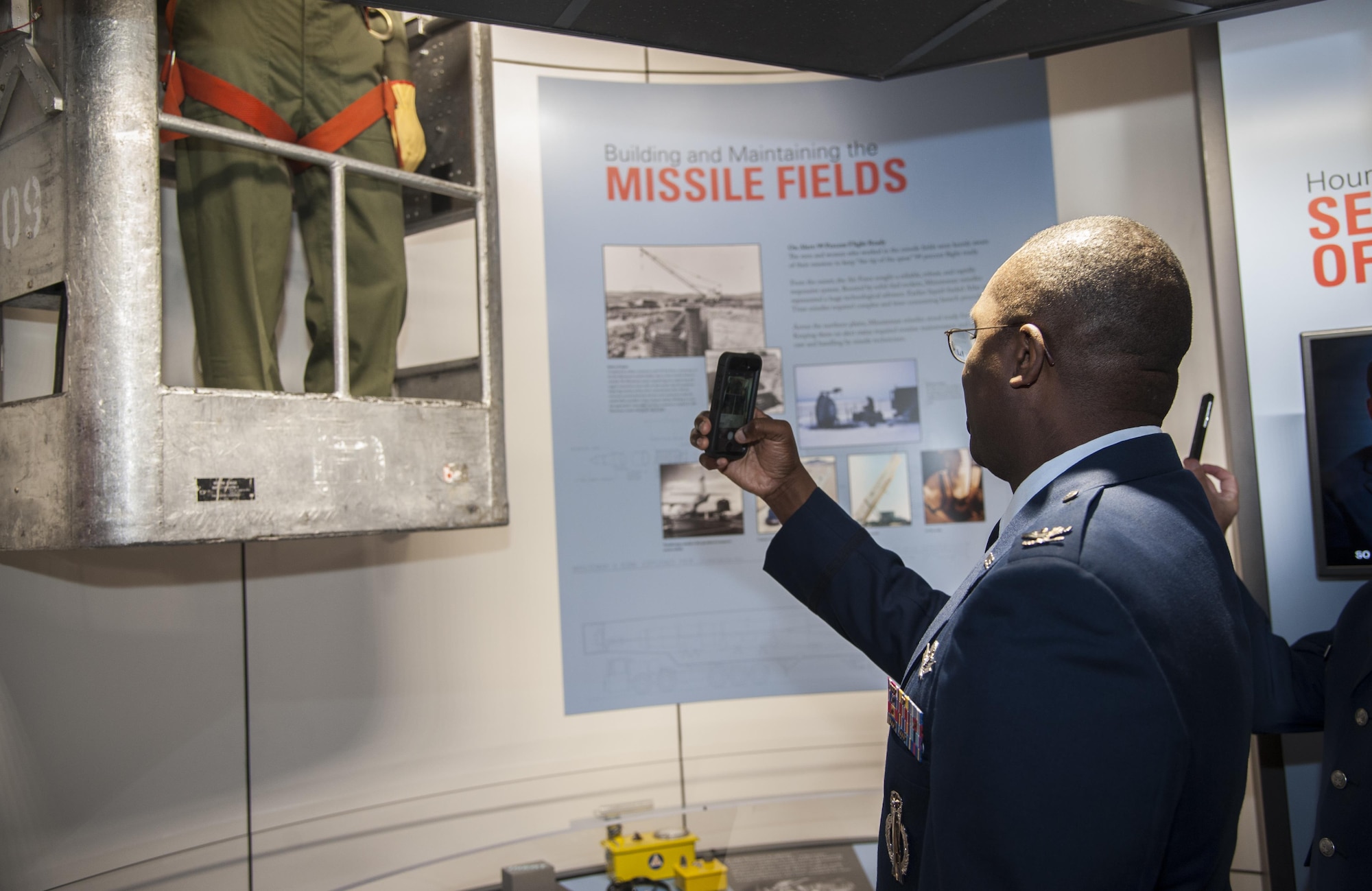 Col. Kelvin Townsend, 91st Missile Wing vice commander, takes a picture of an exhibit at the Minuteman Missile National Historic Site, Philip, S.D., Sept. 24, 2016. Townsend, along with other Air Force leadership, were invited to attend the grand opening of the site’s visitor center. (U.S. Air Force photo/Airman 1st Class Christian Sullivan)