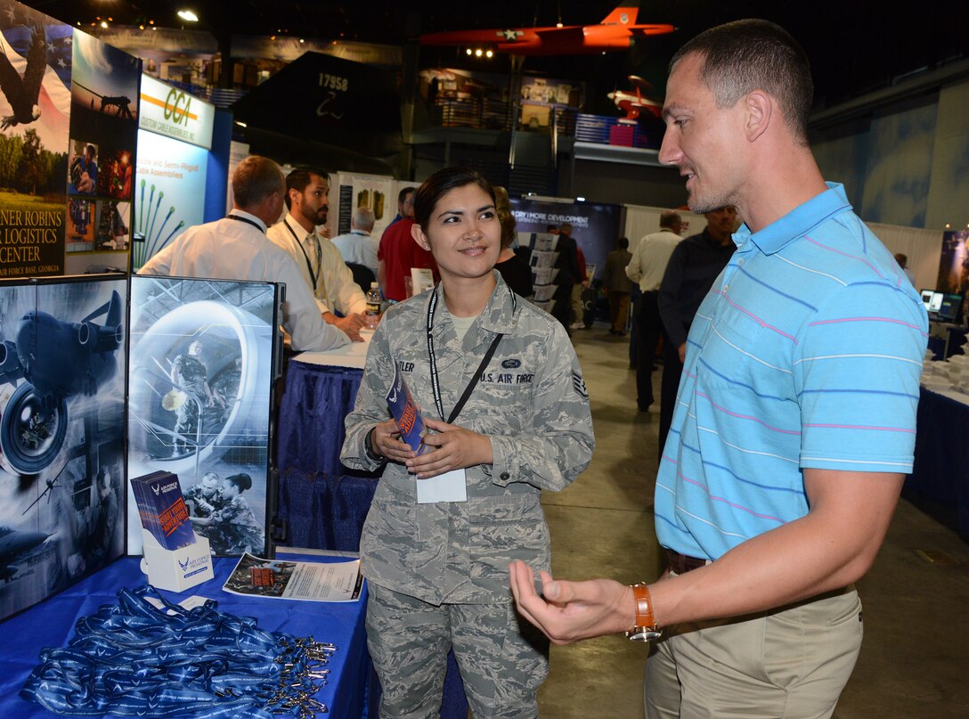 Then Staff Sgt. Kristine Butler, a lline recruiter from the 94th Airlift Wing, Dobbins Air Reserve Base, Ga., talks to prospective recruit at a trade show at Robins Air Force Base, Ga.(Air Force photo/Master Sgt. Chance Babin)