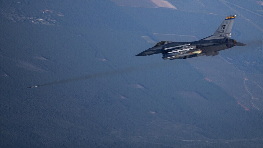 An F-16 pilot from the Arizona Air National Guard Air Reserve Test Center fires an Advanced Precision Kill Weapon System II integrated M151 warhead during a test mission over the Eglin Air Force Base range in July. The system turns existing Hydra 70 unguided rockets into precision guided munitions through the addition of a laser guidance kit. The Arizona Air National Guard Air Reserve Test Center worked with the 96th Test Wing community on the tests. (Courtesy Photo)
