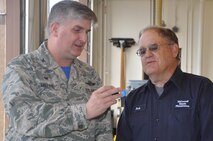 Bob Sommerhauser, 22nd Logistics Readiness Squadron fire truck mechanic, right, receives a pin from Col. Albert Miller, 22nd Air Refueling Wing commander, Aug. 26, 2016, at McConnell Air Force Base, Kan. Sommerhauser received the pin for dedicating 40 years to working as a mechanic at McConnell. (U.S. Air Force photo/Ashley M. Wright)