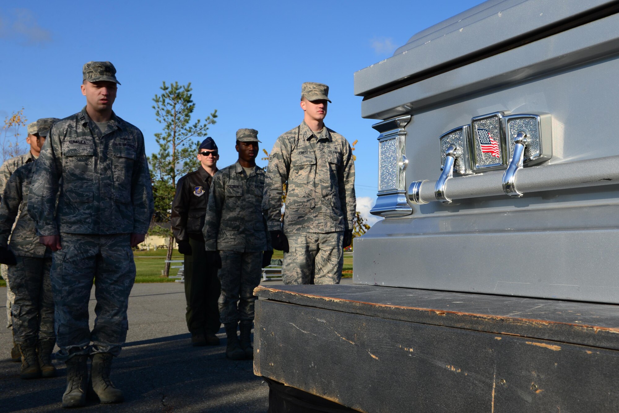 Members of the Eielson Honor Guard and 354th Fighter Wing leadership pause in front of a mock casket Sept. 26, 2016, at Eielson Air Force Base, Alaska. The Honor Guard taught leadership how to properly approach, check and lift a casket for a military funeral detail. (U.S. Air Force photo by Airman 1st Class Cassandra Whitman)