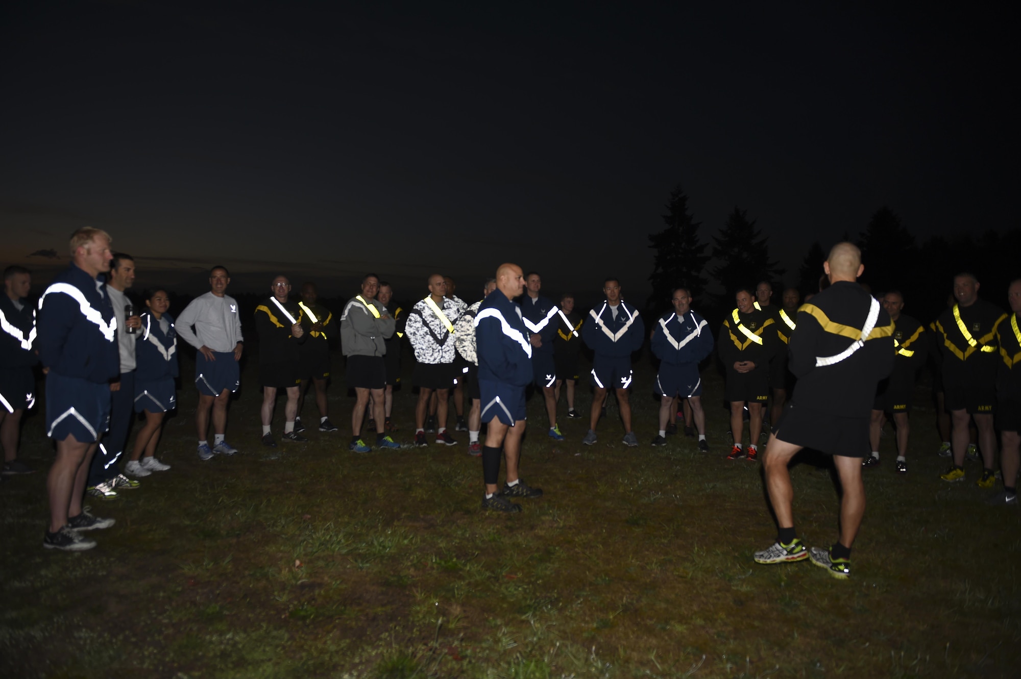 Air Force and Army senior enlisted members are briefed by Command Sgt. Major Michael Anthony Grinston, 1st Corps Headquarters, and Chief Master Sgt. Tico Mazid, 62nd Airlift Wing Command Chief, Sept. 29, 2016 at Heritage Hill on Joint Base Lewis-McChord, Wash., before a physical training session. The senior enlisted members at JBLM were using the joint physical training session as a team building exercise. (U.S. Air Force photo/Staff Sgt. Naomi Shipley)