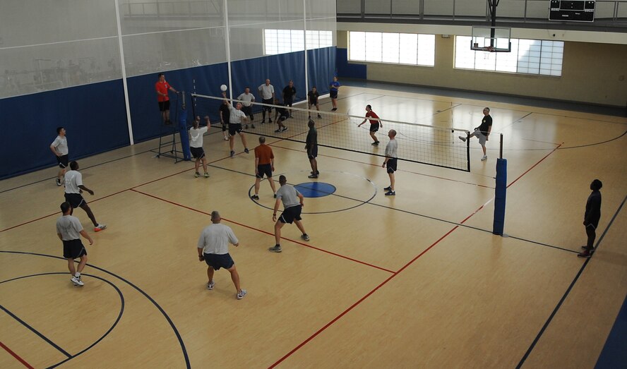 Colonels and chief master sergeants compete in a volleyball match during sports day at Barksdale Air Force Base, La., Sept. 30, 2016. The match was a part of sports day, an annual event giving Airmen the opportunity to participate in team sports, and help increase morale and fitness awareness. (U.S. Air Force photo/Airman Alexis Schultz)