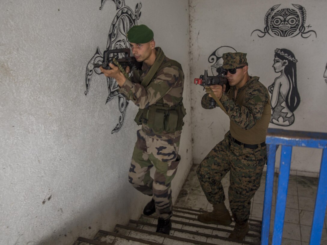 TARAVAO, Tahiti – U.S. Marine Lance Cpl. Jacob Richey, an administrative clerk with Headquarters Company, Task Forces Koa Moana 16-4, clears a stairway with French forces during urban operations training in Taravao, Tahiti, Sept. 23, 2016. American and French forces worked together to build partnership and learn from each other’s tactics. (U.S. Marine Corps photo by Lance Cpl. Quavaungh Pointer)