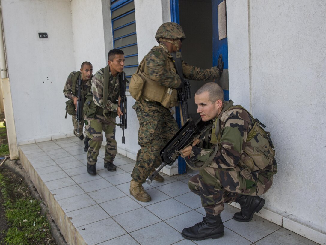TARAVAO, Tahiti – U.S. Marine Cpl. Woodrow Jackson, a military police Marine with Law Enforcement Detachment, Task Forces Koa Moana 16-4, enters a room with French forces during urban operations training in Taravao, Tahiti, Sept. 23, 2016. American and French forces worked together to build partnership and learn from each other’s tactics. (U.S. Marine Corps photo by Lance Cpl. Quavaungh Pointer)