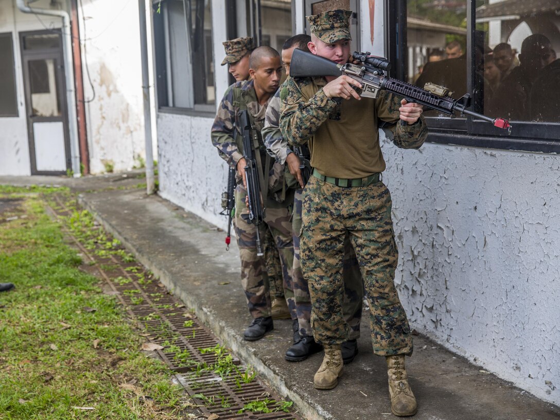 TARAVAO, Tahiti – U.S. Marine Lance Cpl. Cory Walters, a combat engineer with Combat Engineer Platoon, Task Forces Koa Moana 16-4, prepares to enter a room with French forces during urban operations training in Taravao, Tahiti, Sept. 23, 2016. American and French forces worked together to build partnership and learn from each other’s tactics. (U.S. Marine Corps photo by Lance Cpl. Quavaungh Pointer)