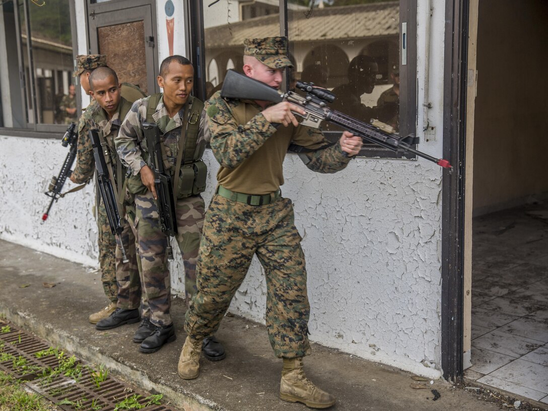 TARAVAO, Tahiti – U.S. Marine Lance Cpl. Cory Walters, a combat engineer with Combat Engineer Platoon, Task Forces Koa Moana 16-4, prepares to enter a room with French forces during urban operations training in Taravao, Tahiti, Sept. 23, 2016. American and French forces worked together to build partnership and learn from each other’s tactics. (U.S. Marine Corps photo by Lance Cpl. Quavaungh Pointer)
