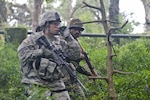 A U.S. Soldier with 5-20th Infantry Regiment, 1-2 Stryker Brigade, and his Indian counterpart move through an improvised explosive device detection course Sept. 17, 2016, at Chaubattia Military Station, India. This was part of Yudh Abhyas 2016, a bilateral training exercise geared toward enhancing cooperation and coordination between the two nations through training and cultural exchanges. 