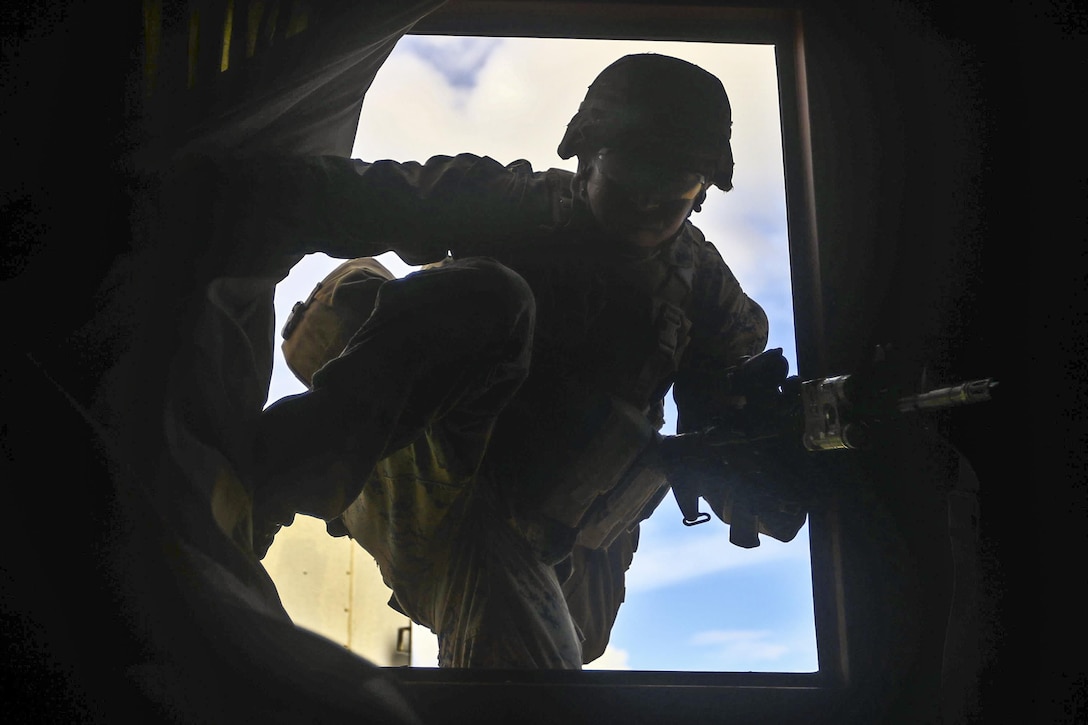 A Marine enters a window during Island Viper at Marine Corps Base Hawaii, Sept. 28, 2016. During the annual training event, Marines cleared buildings, patrolled through simulated villages, completed obstacles for a leadership course and traversed an improvised explosive device course. The Marine is assigned to Alpha Company, 1st Battalion, 3rd Marine Regiment. Marine Corps photo by Cpl. Aaron Patterson