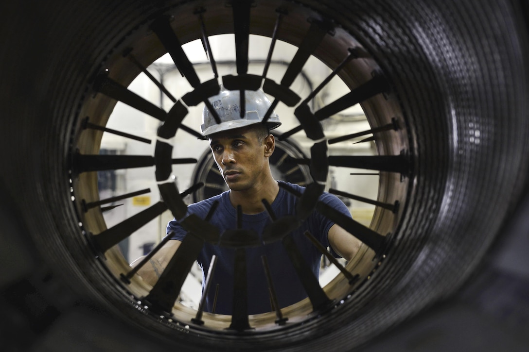 Navy Petty Officer 2nd Class Ganesh Arjun transports an afterburner in the jet shop of the aircraft carrier USS Dwight D. Eisenhower in the Persian Gulf, Sept. 29, 2016. The Eisenhower is supporting Operation Inherent Resolve, maritime security operations and theater security cooperation efforts in the U.S. 5th Fleet area of operations. Navy photo by Seaman Christopher A. Michaels