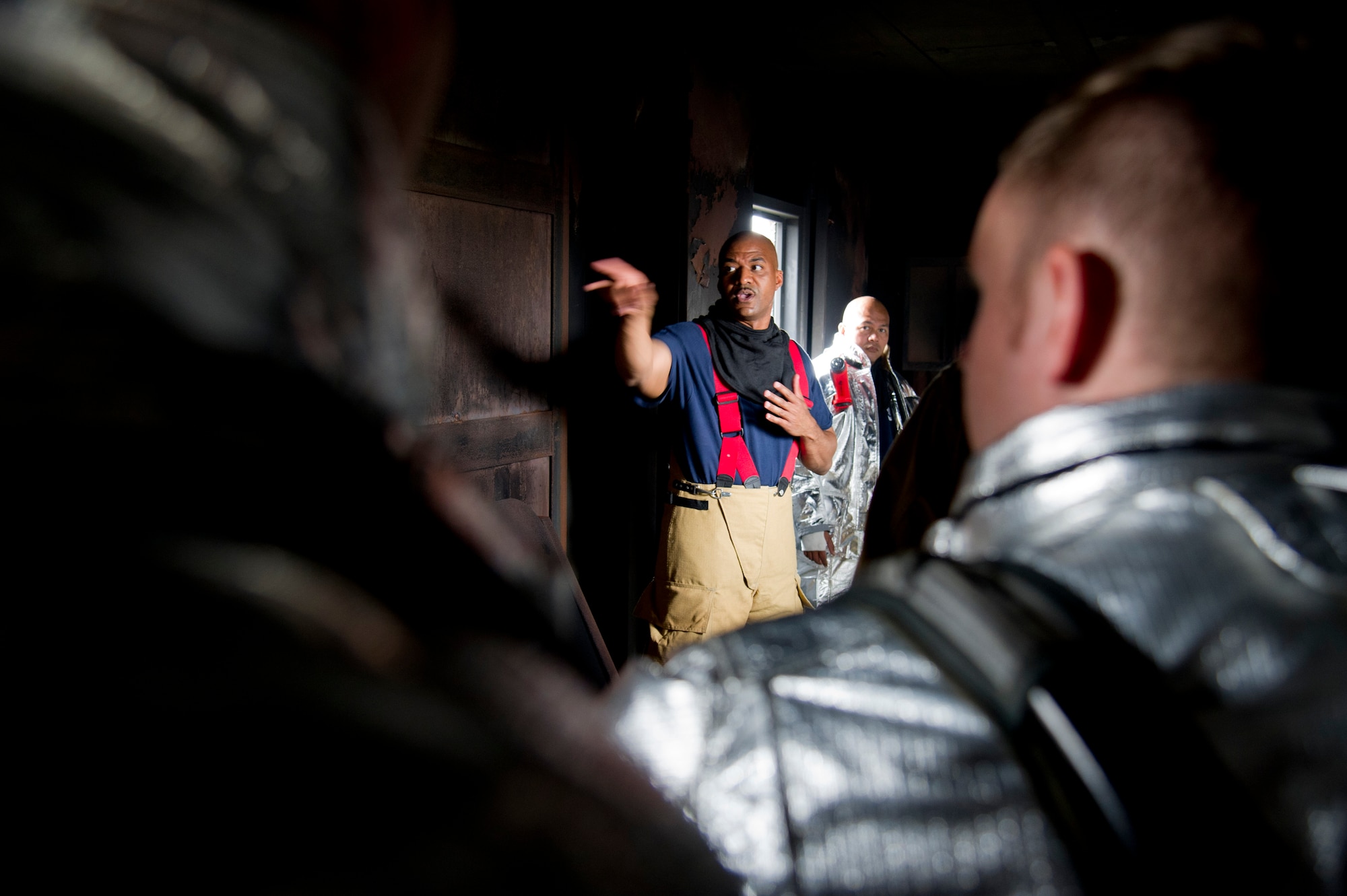 U.S. Air Force Master Sgt. Darnell Walls, 51st Civil Engineer Squadron assistant chief of training, instructs firefighters during a training scenario at Camp Humphreys, Republic of Korea, Sept. 28, 2016. The scenario was a biannual structural firefighting training designed to train in building fires. (U.S. Air Force photo by Staff Sgt. Jonathan Steffen)