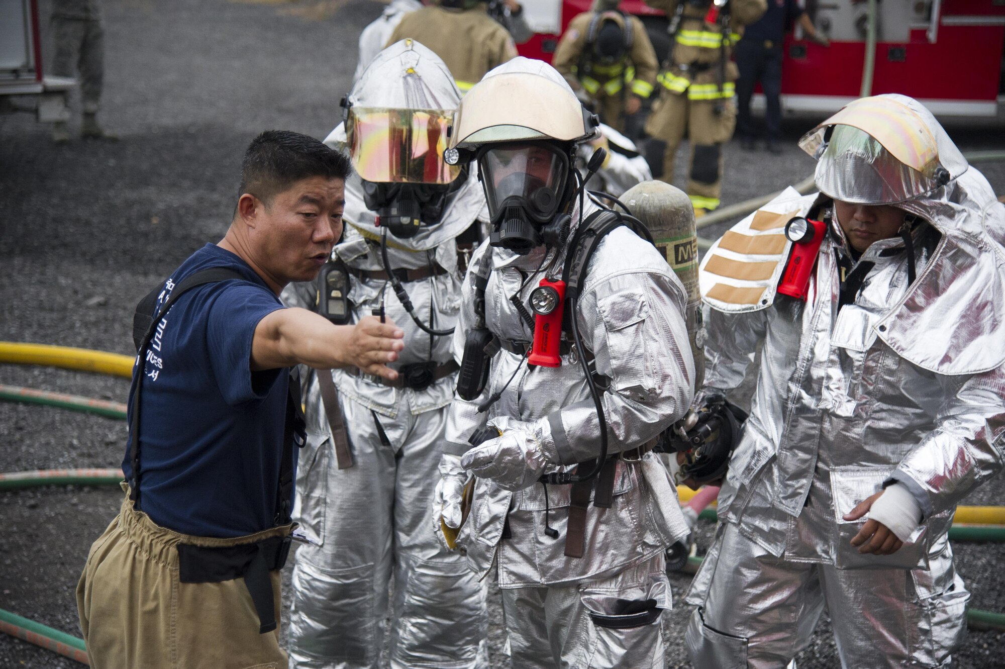 U.S. Air Force Master Sgt. Hungpyo Rucci, 51st Civil Engineer Squadron assistant chief health and safety, gives instructions to firefighters during a training scenario at Camp Humphreys, Republic of Korea, Sept. 28, 2016. Mongrel firefighters used Humphreys’ fire training facilities to maintain currency on their training for structural fires. (U.S. Air Force photo by Staff Sgt. Jonathan Steffen)