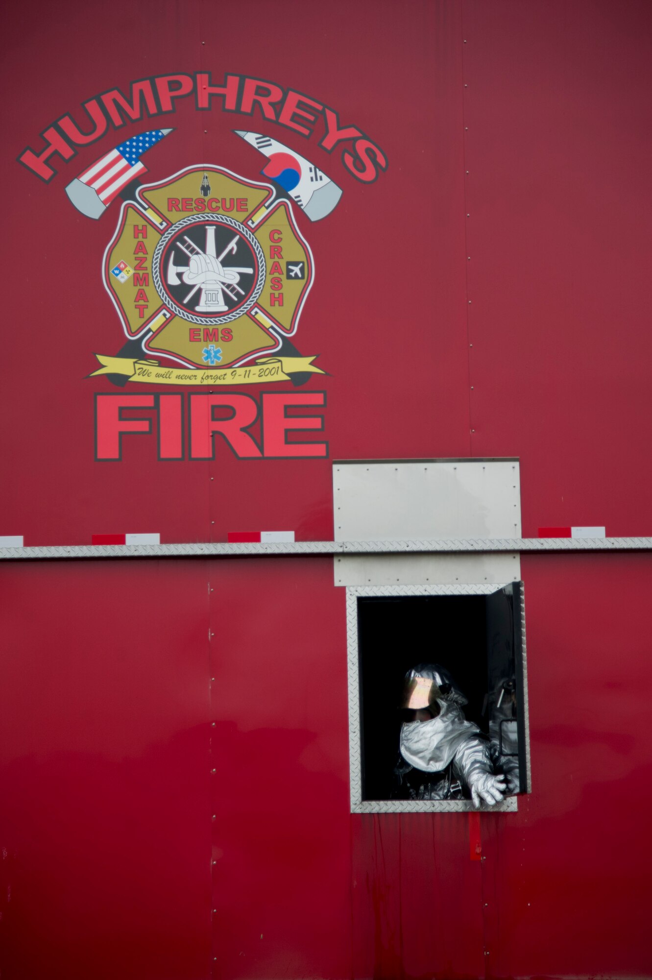 A U.S. Air Force firefighter from the 51st Civil Engineer Squadron opens a window after putting out a fire during structural firefighting training at Camp Humphreys, Republic of Korea, Sept. 28, 2016. Mongrel firefighters used Humphreys’ fire training area to maintain currency on their biannual training requirements. (U.S. Air Force photo by Staff Sgt. Jonathan Steffen)