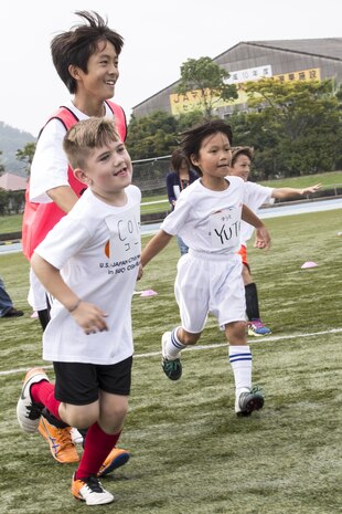Children run around for a warm-up during a game of Doro-kei prior to playing soccer at the U.S.-Japan Children Soccer event at the Suo-Oshima Athletic Field in Suo-Oshima, Japan, Oct. 1, 2016. Doro-kei is a game similar to the American “Cops and Robbers”. Participating in the event gave the children an opportunity to learn new things. (U.S. Marine Corps photo by Lance Cpl. Joseph Abrego)