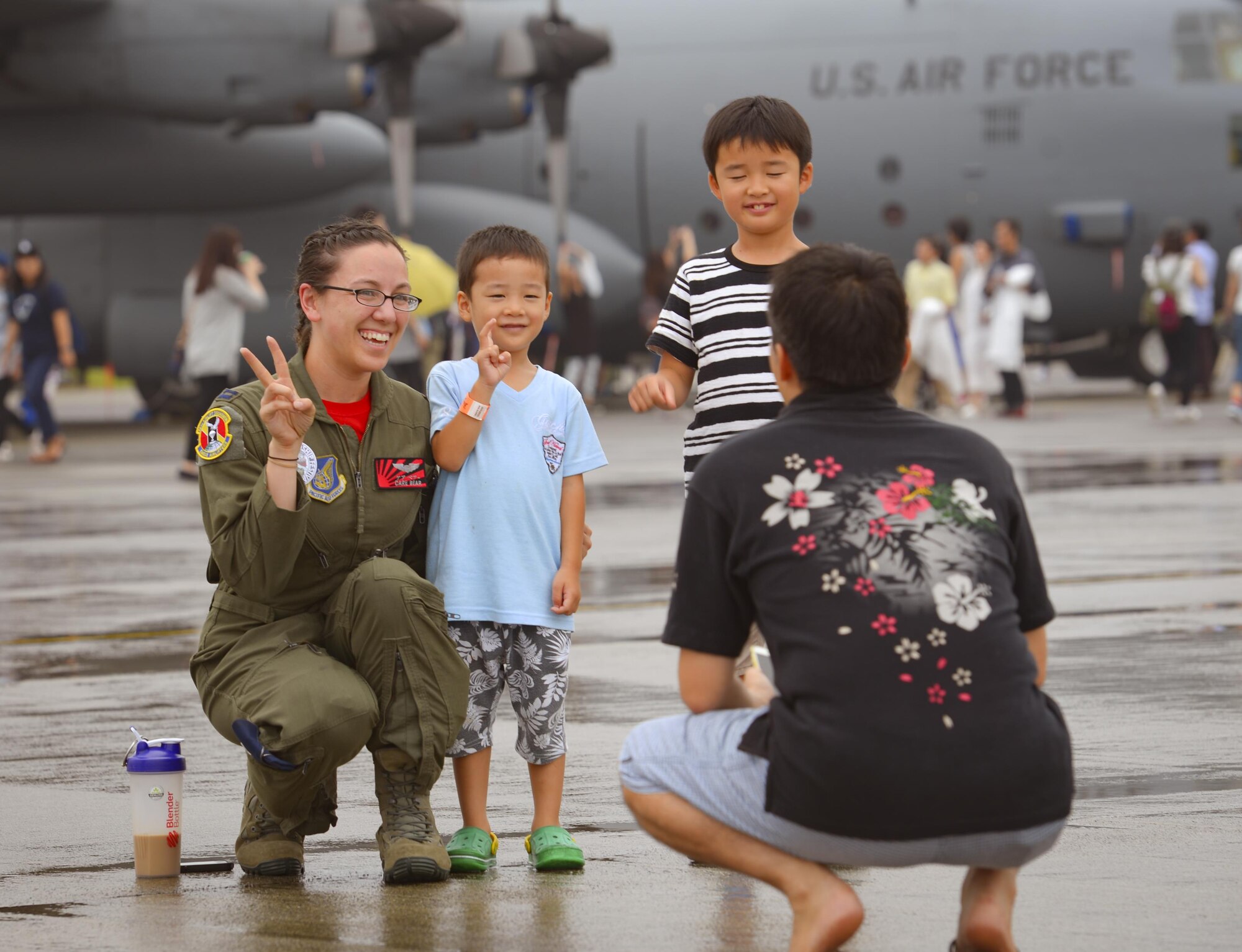 Festivalgoers pose with Captain Sydney Croxton, 36th Airlift Squadron C-130H Hercules pilot, during the 2016 Japanese-American Friendship Festival at Yokota Air Base, Japan, Sept. 17, 2016. The festival is held annually and offers the US military on base a chance to share their work and culture with their off-base neighbors. More than 185,000 people attended in 2015. (U.S. Air Force photo by Airman 1st Class Elizabeth Baker/Released)
