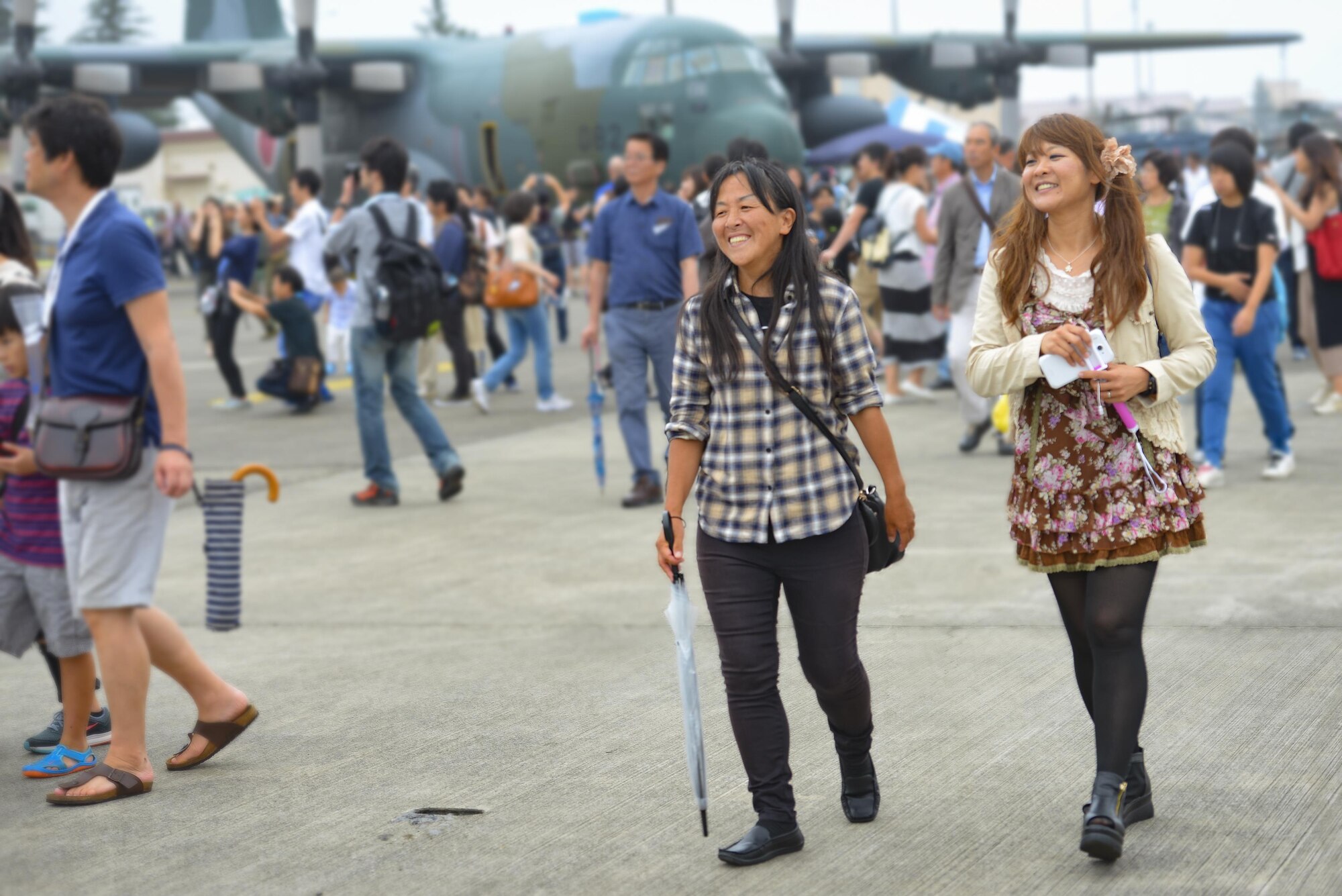 Festivalgoers explore the flight line during the 2016 Japanese-American Friendship Festival at Yokota Air Base, Japan, Sept. 17, 2016. The festival gives community members a chance to come onto Yokota to see static aircraft, witness military demonstrations, learn about the capabilities and training done at Yokota and to meet with the US and Japan Self-Defense Force members who work and live here. (U.S. Air Force photo by Airman 1st Class Elizabeth Baker/Released)