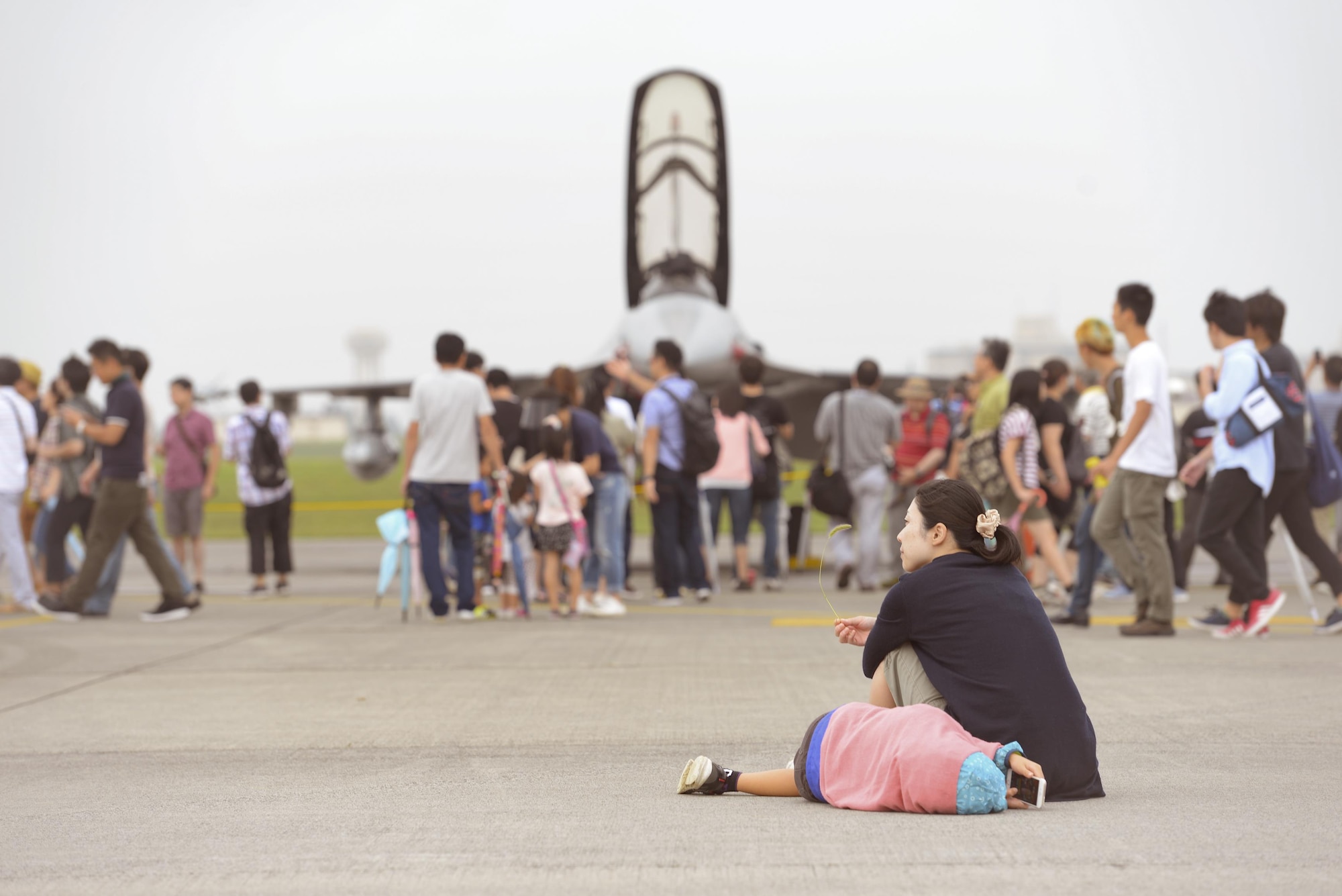 Festivalgoers relax and explore the flight line during the 2016 Japanese-American Friendship Festival at Yokota Air Base, Japan, Sept. 17, 2016. The festival gives community members a chance to come onto Yokota to see static aircraft, witness military demonstrations, learn about the capabilities and training done at Yokota and to meet with the US and Japan Self-Defense Force members who work and live here. (U.S. Air Force photo by Airman 1st Class Elizabeth Baker/Released)