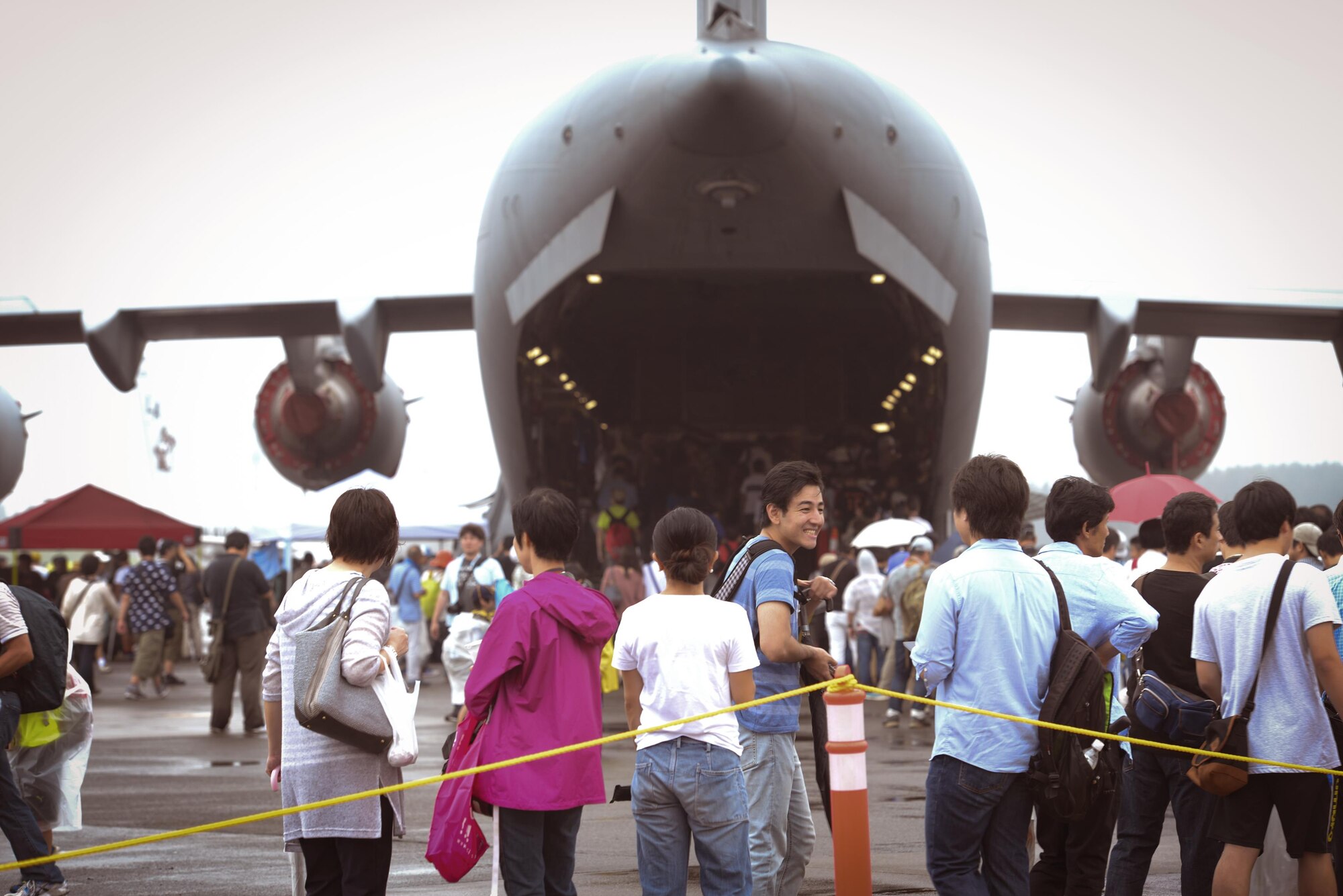 Festivalgoers wait in line to explore a C-5 Galaxy static aircraft display during the 2016 Japanese-American Friendship Festival at Yokota Air Base, Japan, Sept. 17, 2016. The festival gives community members a chance to come onto Yokota to see static aircraft, witness military demonstrations, learn about the capabilities and training done at Yokota and to meet with the US and Japan Self-Defense Force members who work and live here. (U.S. Air Force photo by Airman 1st Class Elizabeth Baker/Released)