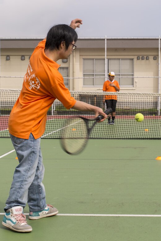 An athlete participates in a game of tennis during the Special Olympics Nippon Hiroshima at Marine Corps Air Station Iwakuni, Japan, Oct. 2, 2016. Activities held at the Special Olympics included basketball, futsal, tennis, bowling and a duathlon. This program provides year-round training for upcoming competitions in a variety of Olympic-style sports, and it is catered to children and adults with mental and learning disabilities. As the 10th Special Olympics Hiroshima held at the air station, event coordinators hope to publicize the event and encourage more athletes to compete. (U.S. Marine Corps photo by Lance Cpl. Aaron Henson)