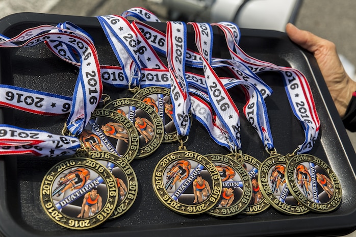 Athletes received medals after completing a duathlon during the Special Olympics Nippon Hiroshima at Marine Corps Air Station Iwakuni, Japan, Oct. 2, 2016. The Special Olympics instills confidence, inspires a sense of competition and improves health through the transformative power of sports. Hosting the event here helps service members and their families build stronger relationships with Japanese civilians by breaking language barriers and promoting positive interaction in a foreign country. (U.S. Marine Corps photo by Lance Cpl. Aaron Henson)