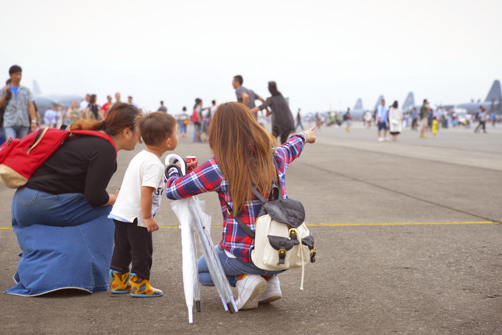 Festivalgoers explore the flight line during the 2016 Japanese-American Friendship Festival at Yokota Air Base, Japan, Sept. 17, 2016. The festival gives community members a chance to come onto Yokota to see static aircraft, witness military demonstrations, learn about the capabilities and training done at Yokota and to meet with the US and Japan Self-Defense Force members who work and live here. (U.S. Air Force photo by Airman 1st Class Elizabeth Baker/Released)