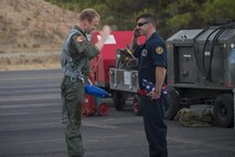 Royal Netherlands air force Capt. Tim Peijneburg, pilot from Leeuwarden Airbase, The Netherlands, returns a salute from U.S. Air Force Staff Sgt. Andrew Augustine, 48th Aircraft Maintenance Squadron dedicated crew chief, after they return each other's flags from being flown at Tactical Leadership Programme 16-3 at Los Llanos Air Base, Spain, Sept. 26.  Training programs like TLP showcase how the U.S. works side-by-side with NATO Allies and partners every day, training to meet future security challenges as a unified force. (U.S. Air Force photo/ Staff Sgt. Emerson Nuñez)