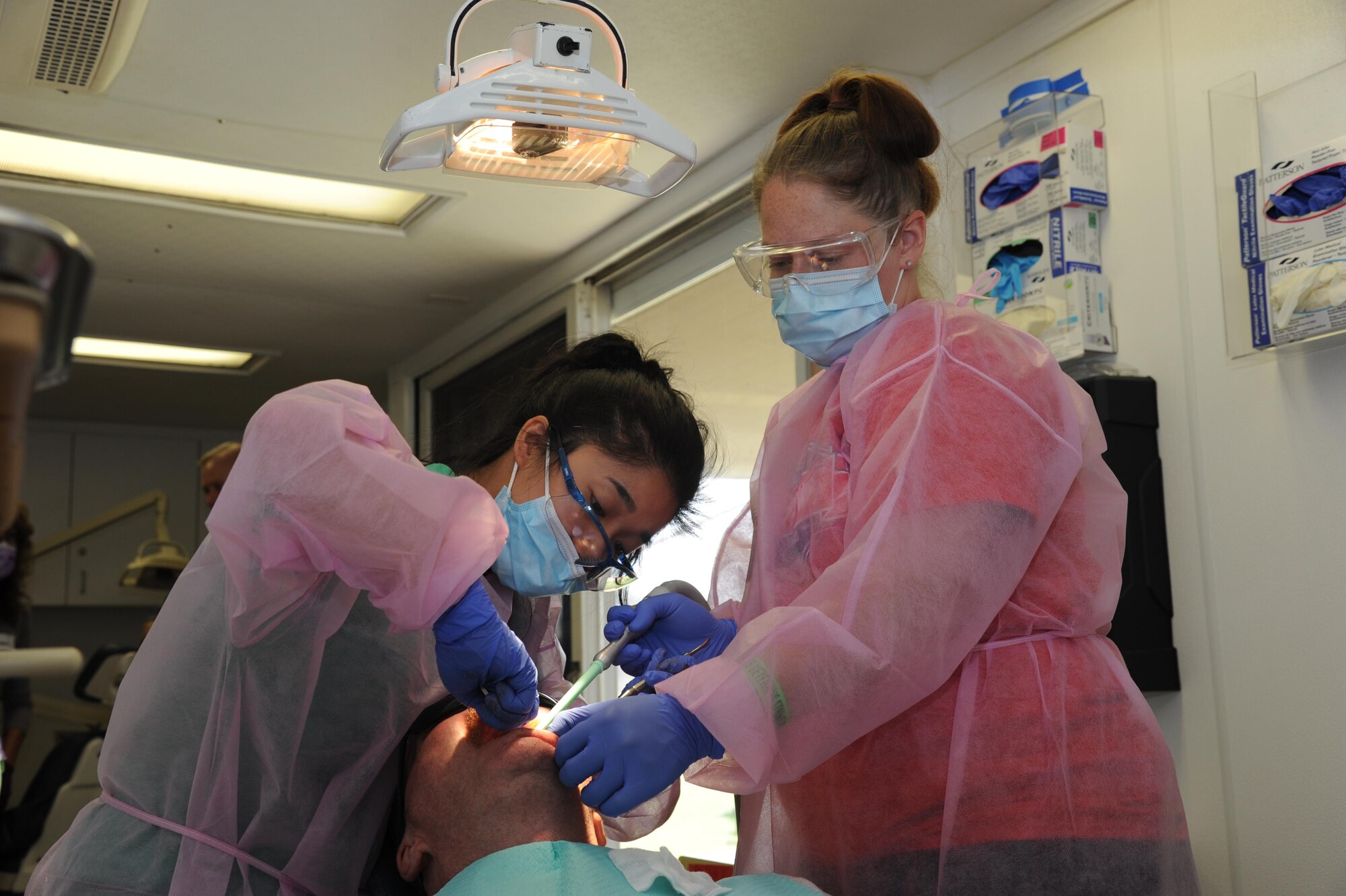 Staff. Sgt. Sharon Palmer, (on right) dental assistant, 6 Air Mobility Wing, MacDill Air Force Base along with Maj. Elizabeth Ho, 927th Aerospace Medical Squadron, D.M.D provide dental care during Operation Stand Down, an event designed to help local homeless veterans combating life on the streets. The event, held at the Veteran Memorial Park, Hudson, Florida, bussed in homeless veterans from surrounding areas to take advantage of the more than a dozen complimentary services, such as employment workshops, hot meals, hot showers and haircuts, and medical services. (U.S. Air Force photo by Tech. Sgt. Peter Dean)