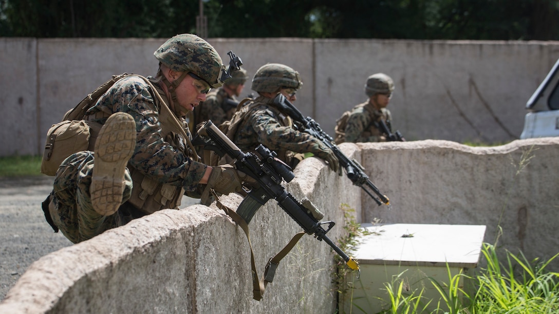 Marines with Charlie Company, 1st Battalion, 3rd Marine Regiment, vault over a wall for a room clearing drill during Exercise Island Viper aboard Marine Corps Training Area Bellows, Sept. 29, 2016. Exercise Island Viper is a 3-week-long battalion level training evolution workup that focuses on sharpening the infantry skills of the individual, team and squad. 