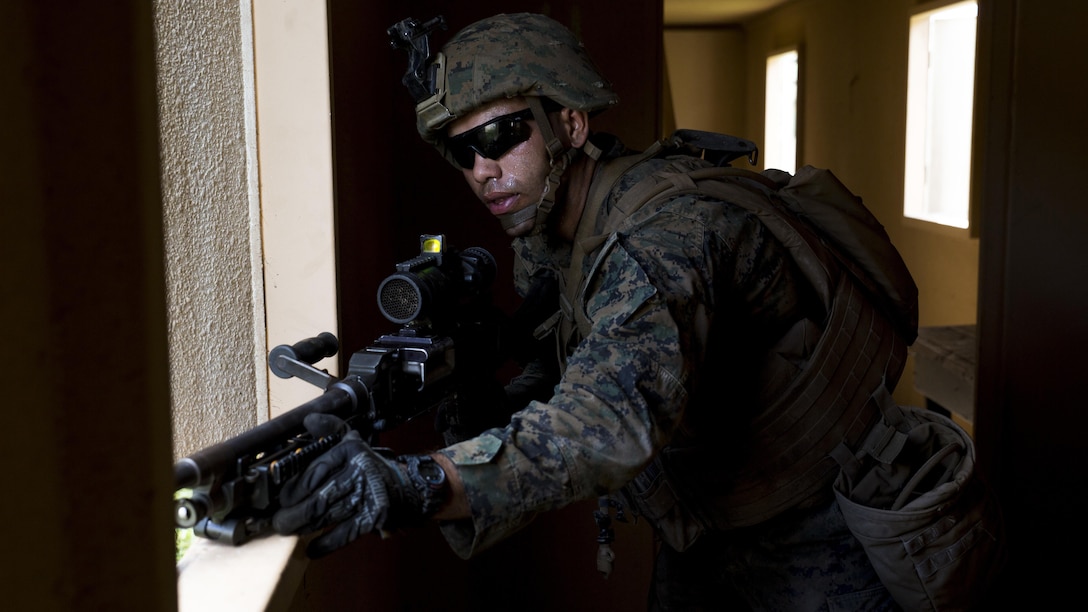 Pfc. Tyler Ruble, a machine gunner with Charlie Company, 1st Battalion, 3rd Marine Regiment, and a Winston-Salem, North Carolina native, interacts with role players during a patrol part of Exercise Island Viper aboard Marine Corps Training Area Bellows, Sept. 29, 2016. Exercise Island Viper is a 3-week-long battalion level training evolution workup that focuses on sharpening the infantry skills of the individual, team and squad. 