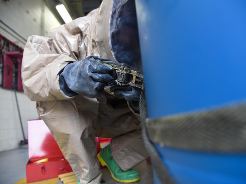 Staff Sgt. Shaun Ouellette, 11th Civil Engineer Squadron readiness and emergency manager, uses a ratchet strap to seal a crack in a plastic barrel during hazardous material training on Joint Base Andrews, Md., Sept. 29, 2016. 11th CES performs hazmat training in order to be prepared to take action if a HAZMAT disaster arises. (U.S. Air Force photo by Airman 1st Class Valentina Lopez)