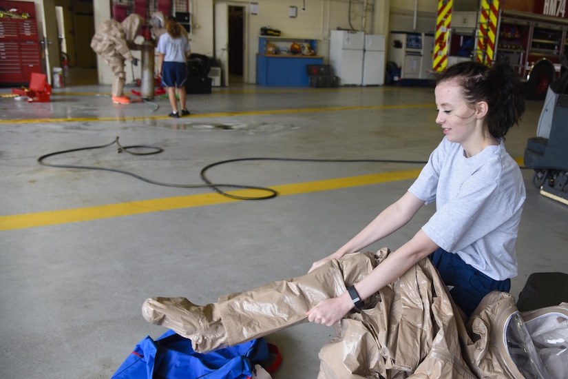 Airman 1st Class Carol Pruitt, 11th Civil Engineer Squadron readiness and emergency manager, dresses in a hazardous material suit during HAZMAT training on Joint Base Andrews, Md., Sept. 29, 2016. HAZMAT training is designed for emergency responders to prepare for toxic leaks, spills or accidents that may cause further damage to life, health, properties or the environment. (U.S. Air Force photo by Airman 1st Class Valentina Lopez)