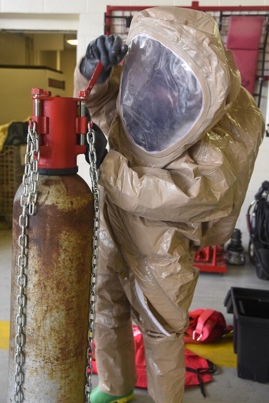 Staff Sgt. Shaun Ouellette, 11th Civil Engineer Squadron readiness and emergency manager, tightens a bolt on an oxygen tank seal during a hazardous material training scenario on Joint Base Andrews, Md., Sept. 29, 2016. 11th CES prioritizes exercises so they are equipped to react to any HAZMAT leakage or spill. The objective of the simulations was to control and stop a leak, which was achieved by tightening bolts, hammering plugs and patching cracks. (U.S. Air Force photo by Airman 1st Class Valentina Lopez)