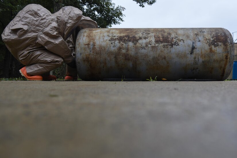 11th Civil Engineer Squadron readiness and emergency managers work on a simulated exercise of a storage tank leak during hazardous material training on Joint Base Andrews, Md., Sept 29, 2016. The purpose of the exercise is to be prepared to handle HAZMAT or react to a toxic spill mishap that may result in destruction. Fire Station One provided simulations, which included a one ton storage tank, oxygen tank and plastic barrel. (U.S. Air Force photo by Airman 1st Class Valentina Lopez)