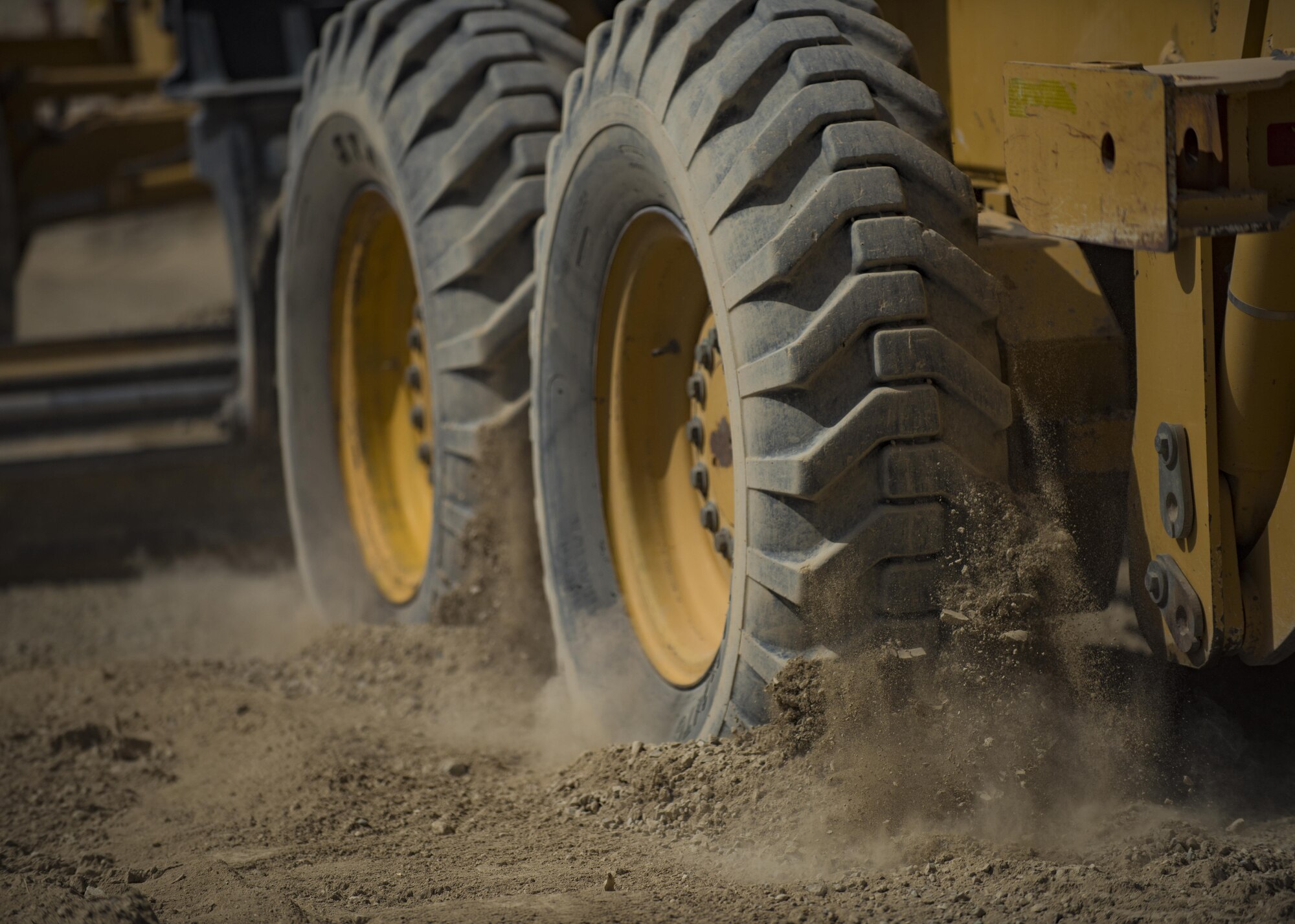 The 455th Expeditionary Civil Engineer Squadron “Dirt Boys”, level gravel with a motor grader, Bagram Airfield, Afghanistan, Oct. 4, 2016. ECES is building a new road around the fence line of the airfield, which will provide a pathway for mine-resistant ambush-protected (MRAP) vehicles to travel. (U.S. Air Force photo by Senior Airman Justyn M. Freeman)