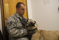 Staff Sgt. Sean King, 319th Security Forces Squadron military working dog handler, comforts his MWD during a vet visit at Minot Air Force Base, N.D., Sept. 28, 2016. The MWDs have two medical check-ups a year to ensure they are fit to carry out their duties. (U.S. Air Force photo/Airman 1st Class Christian Sullivan)