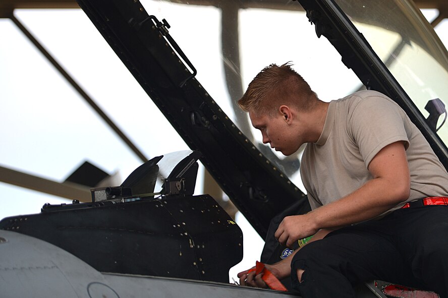 U.S. Air Force Airman 1st Class Michael Gradecki, 20th Aircraft Maintenance Squadron tactical aircraft maintainer, clears the cockpit of an F-16CM Fighting Falcon at Shaw Air Force Base, S.C., Oct. 4, 2016. The cockpits of the aircraft are cleaned out regularly to help ensure pilots are not distracted by loose objects while in flight. (U.S. Air Force photo by Airman 1st Class Christopher Maldonado)