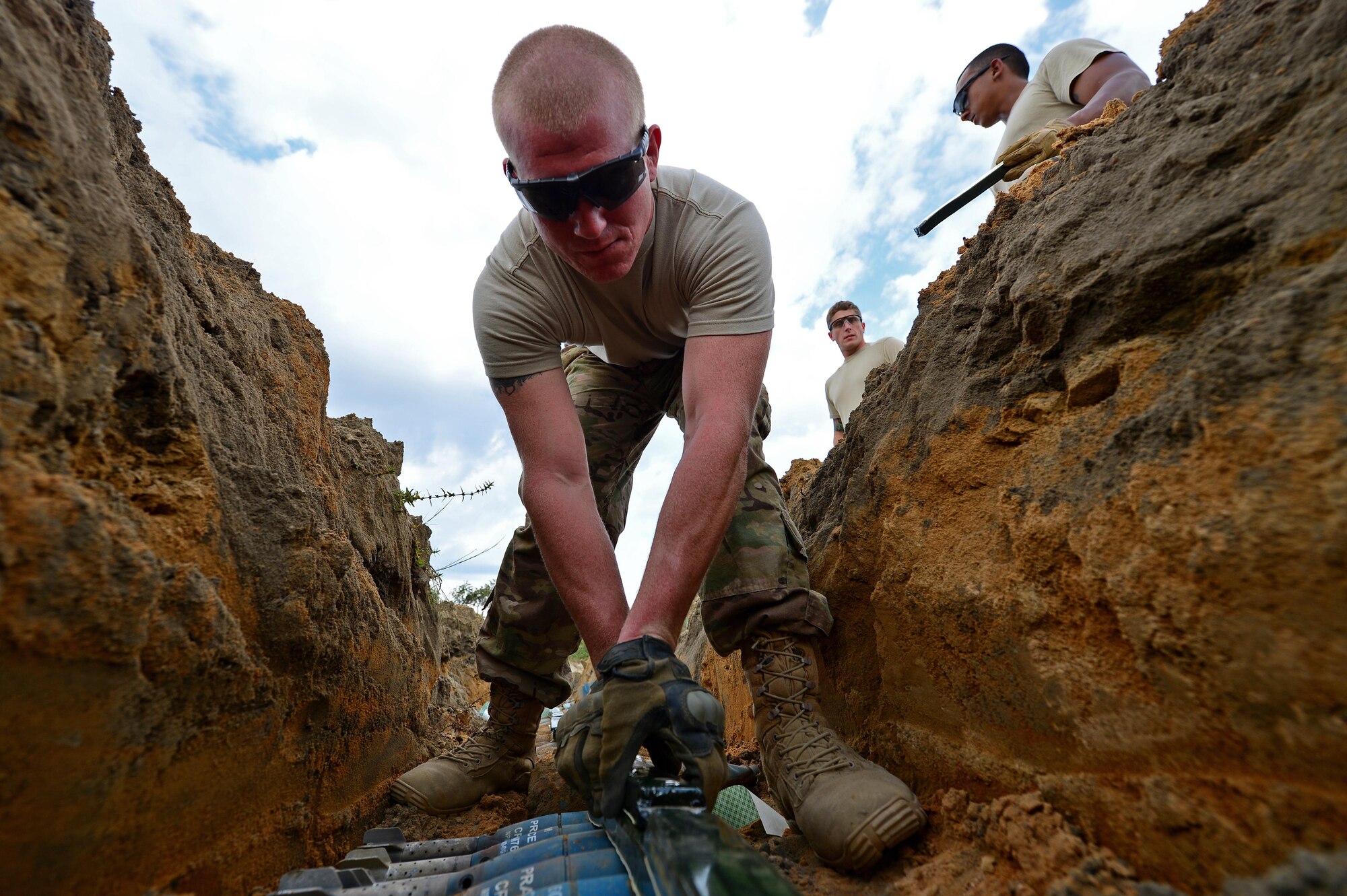 U.S. Air Force Airman 1st Class Tyler Kochlany, 20th Civil Engineer Squadron explosive ordnance disposal apprentice, places C-4 on unexploded dummy bombs at Poinsett Electronic Combat Range, Wedgefield, S.C., Sept. 29, 2016. The EOD Airmen maintain the range to ensure F-16CM Fighting Falcon pilots can continue to prepare and train for future missions. (U.S. Air Force photo by Airman 1st Class Christopher Maldonado) 