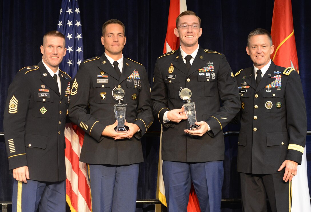NCO of the Year Sgt. 1st Class Joshua Moeller (second from left) and Soldier of the Year Spc. Robert Miller hold their Best Warrior trophies presented by Sgt. Maj. of the Army Daniel Dailey (left) and Vice Chief of Staff of the Army Gen. Daniel Allyn at the AUSA awards luncheon in the Washington Convention Center, Oct. 3, 2016.