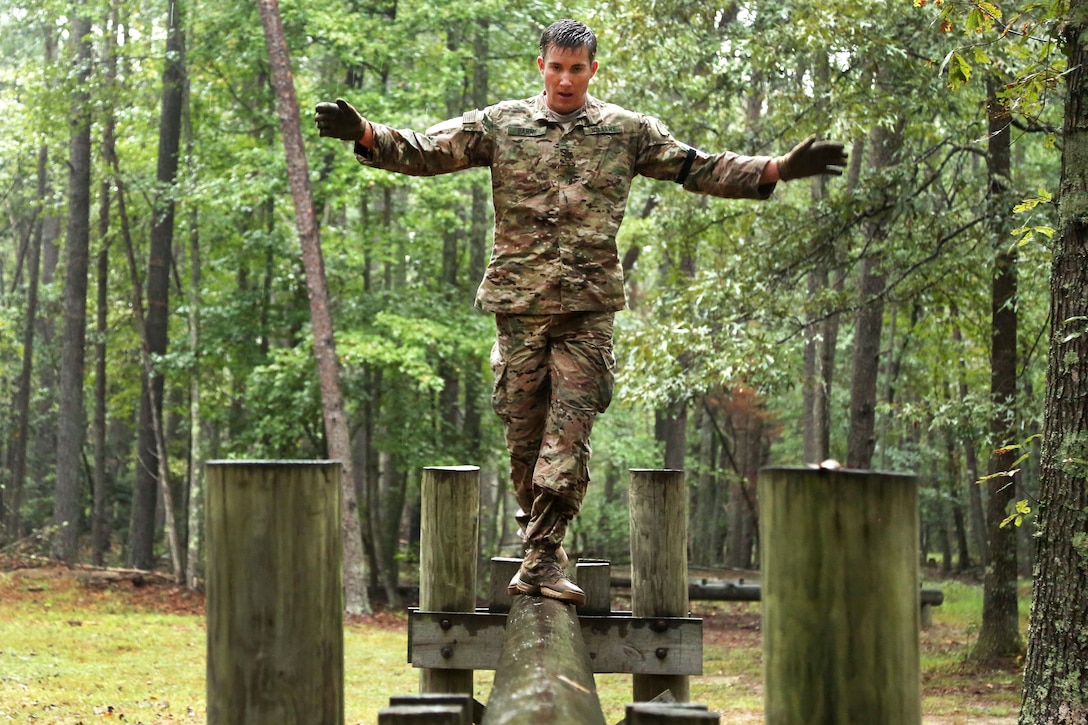 Army Staff Sgt. Clinton Bahme participates in a log balance obstacle event during the Army's 2016 Best Warrior Competition at Fort A.P. Hill, Va., Sept. 27, 2016. Bahme is assigned to the U.S. Army Special Operations Command. Army photo by Pfc. Jada Owens