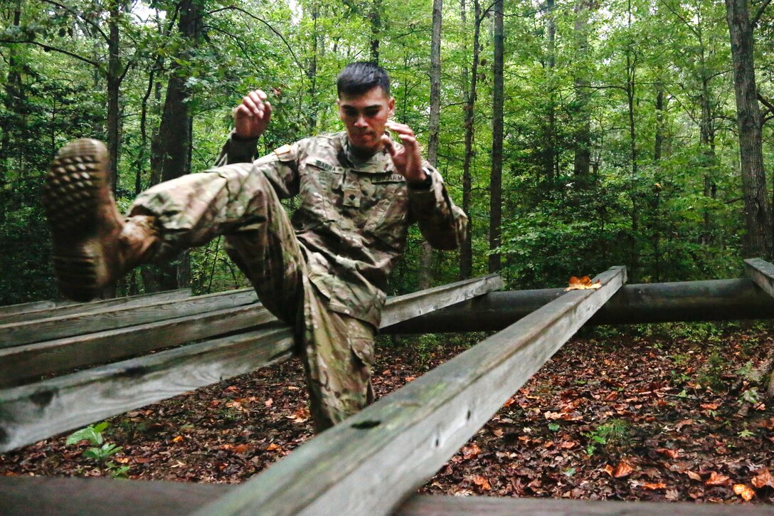 Army Spc. Alan Ibarra-Lepe high-kicks over a hurdle obstacle during the Army's 2016 Best Warrior Competition at Fort A.P. Hill, Va., Sept. 27, 2016. Ibarra-Lepe is assigned to U.S. Army Forces Command. Army photo by Pfc. Fransico Isreal