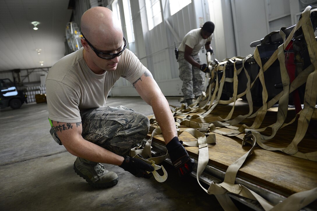 U.S. Air Force Tech. Sgt. Nathan Armstrong, 1st Maintenance Squadron crash disabled damaged aircraft recovery team member, secures cargo during an operational readiness exercise at Joint Base Langley-Eustis, Va., Sept. 28, 2016. The exercise allowed units throughout the base to build operational relationships and learn more about each other’s roles in accomplishing the mission. (U.S. Air Force photo by Airman 1st Class Kaylee Dubois)