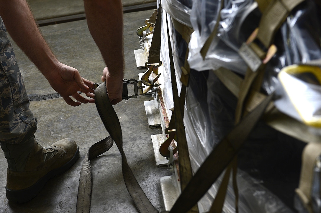 A U.S. Air Force Airman, assigned to the 1st Maintenance Squadron, tightens the cargo netting during an operational readiness exercise at Joint Base Langley-Eustis, Va., Sept. 28, 2016. After reviewing the exercise evaluation, unit leaders will implement any lessons learned from the exercise to improve future operations. (U.S. Air Force photo by Airman 1st Class Kaylee Dubois)