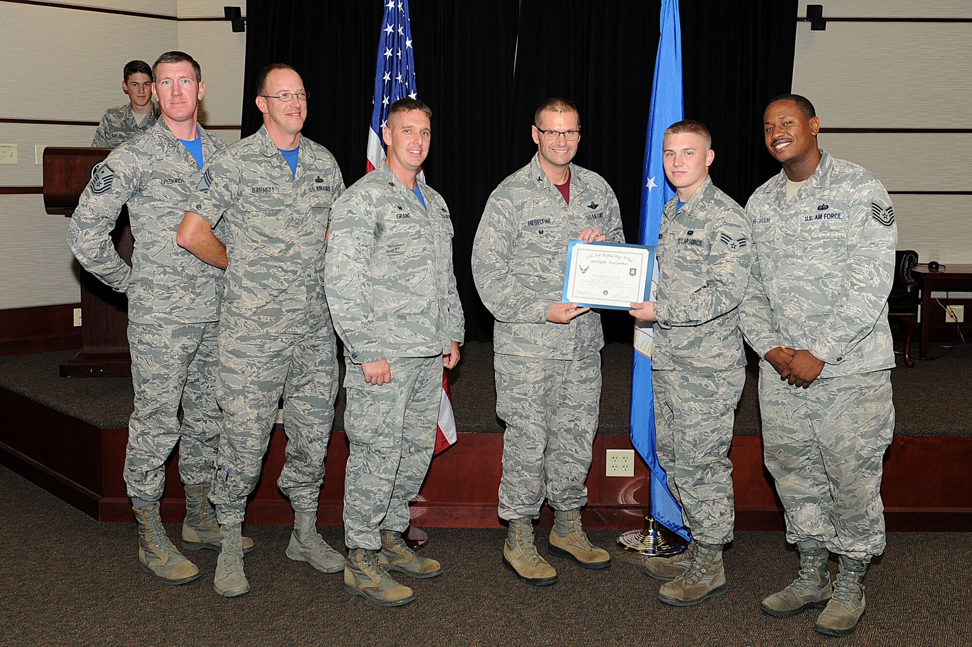 Senior Airman Bryan Krick, 22nd Communications Squadron network infrastructure technician, poses with Col. Phil Heseltine, 22nd Air Refueling Wing vice commander, and 22nd CS leadership, Sept. 30, 2016, at McConnell Air Force Base, Kan. Krick received the spotlight performer for the week of Sept. 19-23. (U.S. Air Force photo/Senior Airman David Bernal Del Agua)