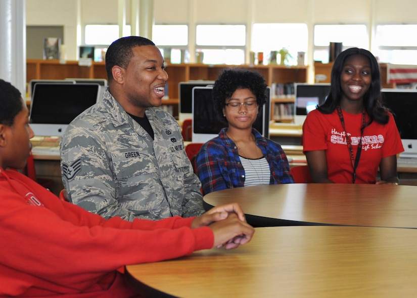 From left, Ronnie Robertson, Hampton High School 10th grade student, U.S. Air Fore Staff Sgt. Mark Green, 1st Operations Support Squadron airfield management NCO in charge, Amisha Valencia, Hampton High School 10th grade student, and Kenya Whitney, Hampton High School geometry teacher, discuss their experiences during Real Access to Diversity team mentoring session at Hampton High School in Hampton, Va., Sept. 30, 2016.  Green has been with the RAD team for a year, and said mentoring the students has been a very rewarding experience. (U.S. Air Force photo by Tech. Sgt. Katie Gar Ward)