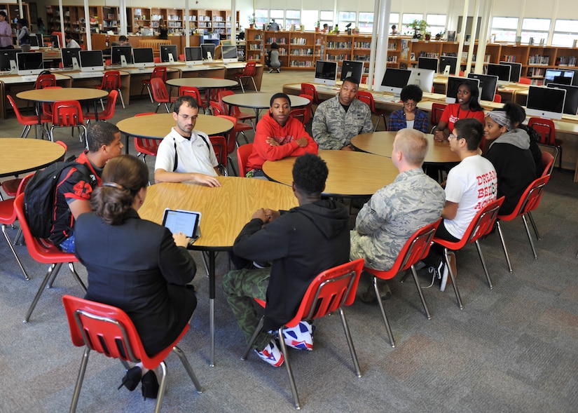 U.S. Air Fore Staff Sgt. Mark Green, 1st Operations Support Squadron airfield management NCO in charge, and Senior Airman Seth Morgan, 1st OSS airfield systems technician, mentor students at Hampton High School in Hampton, Va., Sept. 30, 2016. Green and Morgan are part of the 1st Operation Group’s Real Access to Diversity team, where they incorporate real-world lessons into the students’ curriculum. (U.S. Air Force photo by Tech. Sgt. Katie Gar Ward)