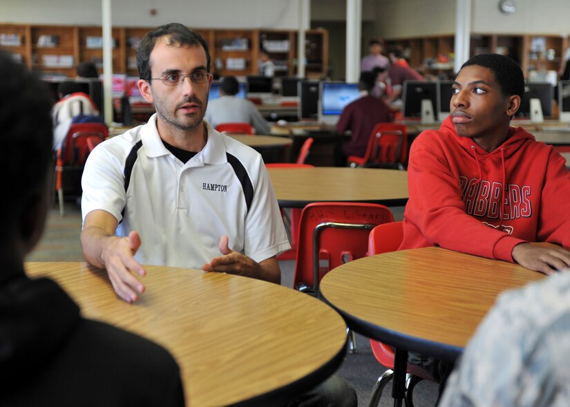 From left, Curtis Blauch, Hampton High School geometry teacher, and Ronnie Robertson, Hampton High School 10th grade student, discuss their experiences during a mentoring session at Hampton High School in Hampton, Va., Sept. 30, 2016.  The session was with the 1st Operations Group’s Real Access to Diversity team, which is a group of Airmen who visit local schools to share experiences with students in science, technology, engineering, and math classes. (U.S. Air Force photo by Tech. Sgt. Katie Gar Ward)